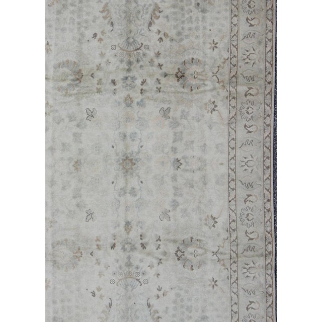 Keivan Woven Arts, Tu-Vey-4611, kwarugs. Produced in mid-20th century, Turkey, this vintage Oushak is characterized by a...