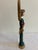 A charming vintage angel figurine featuring dramatic gold feathered wings, a hand-painted face, and flowing green robes...