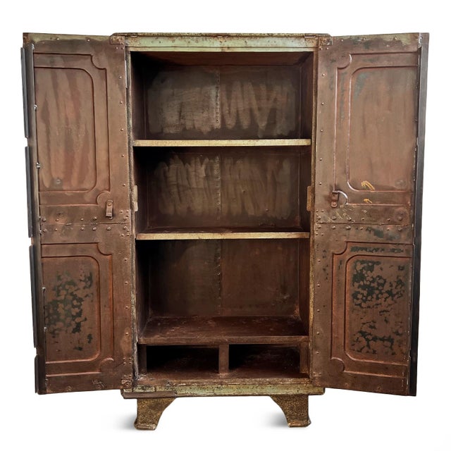 Vintage industrial solid iron safe cabinet. One of a kind with characteristic aged patina. Shelving inside with space...