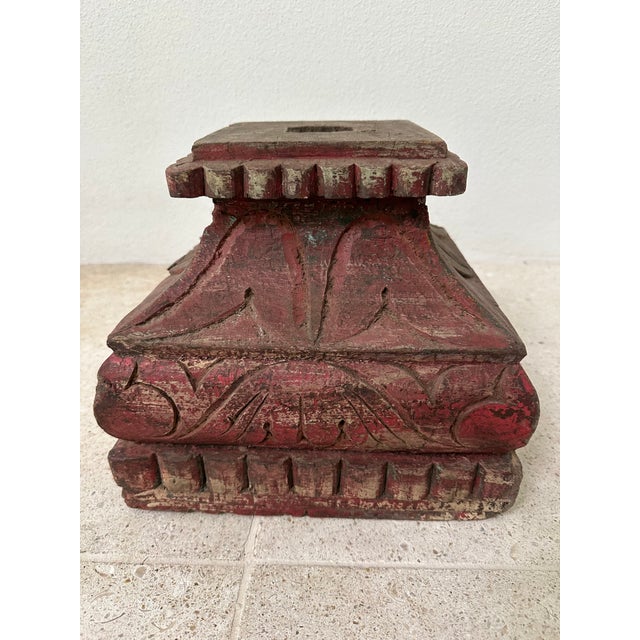 Antique carved wooden architectural plinth from India with deeply carved lotus and bead motifs and a richly worn surface....