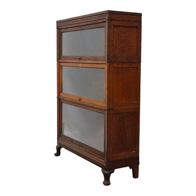 An antique Macey 3-stack barrister bookcase, crafted from oak around 1920. This functional and decorative piece features...