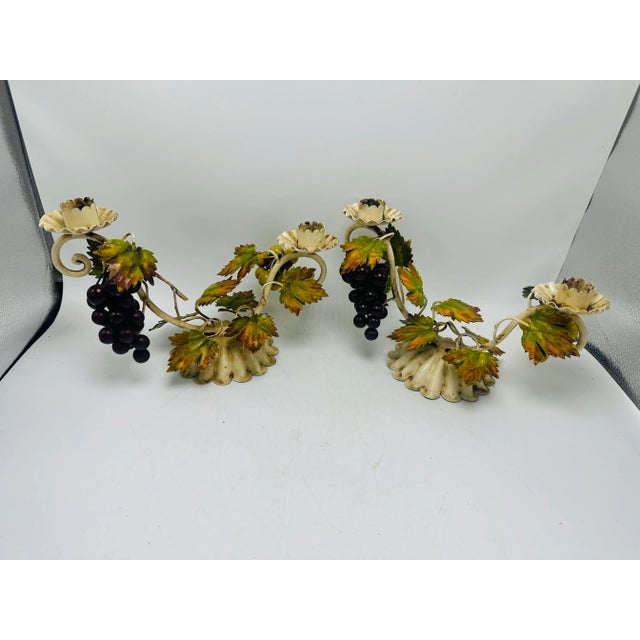 This is a pair of vintage Italian tôle (toleware) candle holders in a grapevine motif. Here’s a detailed description:...