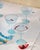 Set of six lovely soft baby blue color coupe cocktail glasses with ripple optic swirl design and red rim. Brand new never...