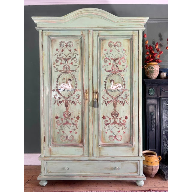 Stunning antique wardrobe, we have painted and added Versailles inspired door panels depicting swans with an aged patina ....
