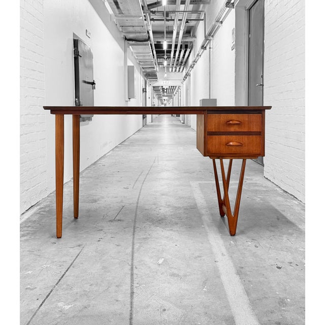 Danish writing desk in teak, c. 1960s, in the style of E.W. Bach. A particularly light and sculptural design combining a...