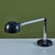 Tubular Desk Lamp by Robert Haussmann, c.1960s, Switzerland, has a sleek minimalist design. The lamp features a black...