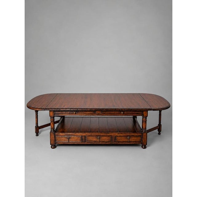 A charming and practical double-sided coffee table by old new england , featuring a rich, warm wood finish and timeless...