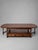 A charming and practical double-sided coffee table by old new england , featuring a rich, warm wood finish and timeless...