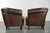 This sturdy set of two English-style sheepskin club armchairs features a beautiful dark brown color and is finished with...