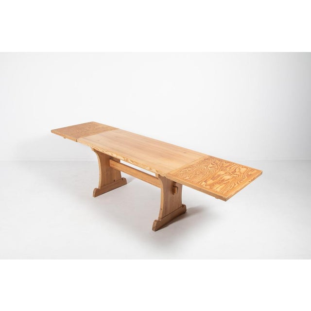 Large Scandinavian Modern solid pine table with additional extensions by Axel Einar Hjorth for Nordiska Kompaniet, 1930s....