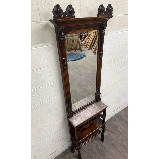 This is a stunning antique Victorian Eastlake hall or entry pier mirror featuring a large original mirror, carved floral...