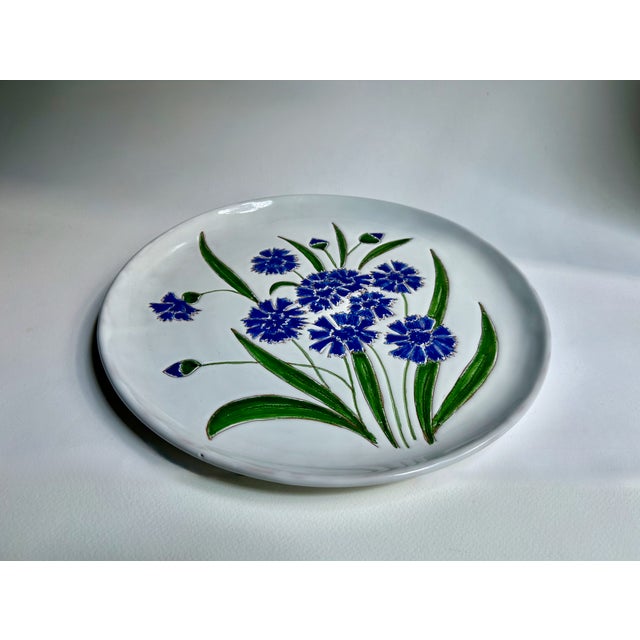 Vintage hand painted glazed White Pottery Platter with Blue Bachelor Buttons & Green Leaves. Featuring a lipped circular...