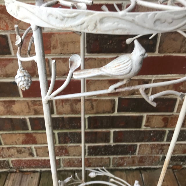 This is a beautiful mid century wrought and/or cast iron plant stand featuring birds (cardinals?), pine cones and pine...