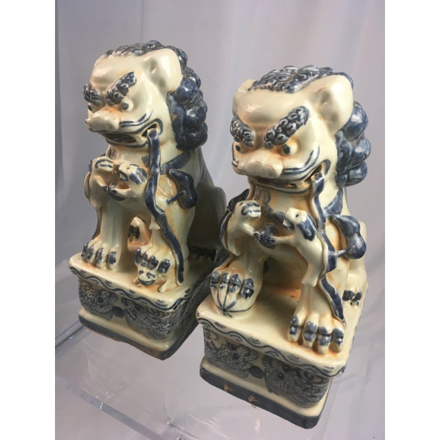 Great pair of handmade antique Chinese foo dogs, in classic blue and white! Slight variation, they were not mass produced,...