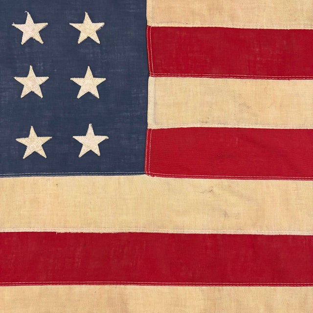 This vintage American flag is made from a very thin cotton cloth with fully sewn stars and stripes. Please note staining...