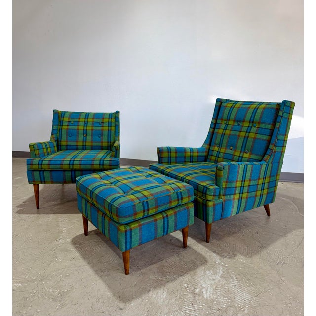 Outstanding pair of Mid Century Modern Lounge Chairs c.1950’s in Blue and Green Plaid fabric with matching ottoman. In the...