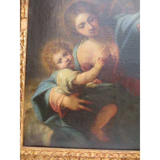19th century Canvas and frame with a dramatic vision of the Madonna holding the Child while showing a Mother and Child...