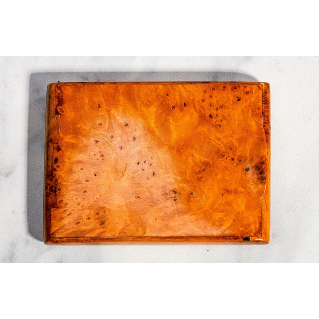 Dating to the early 20th century, this handsome antique wooden cigarette case is a wonderful example of understated...