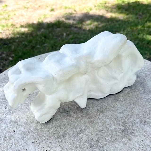 A striking minimalist abstract sculpture featuring an organic, free-form silhouette with soft undulating contours and...