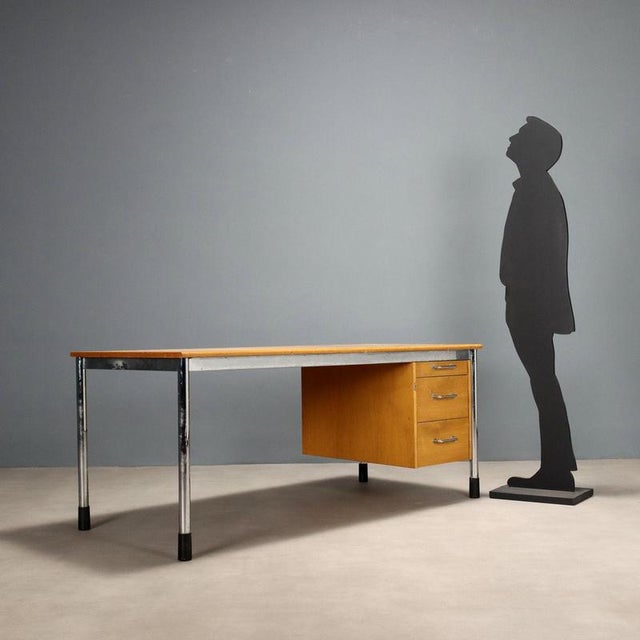 Vintage desk with rectangular wooden top, chromed metal legs with plastic ends and two drawers. Decent condition. This...