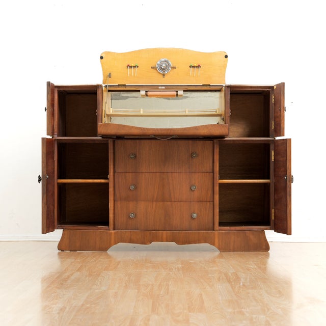 This vintage mid-century cocktail cabinet credenza was designed and manufactured by Glendale of London during the 1950s....