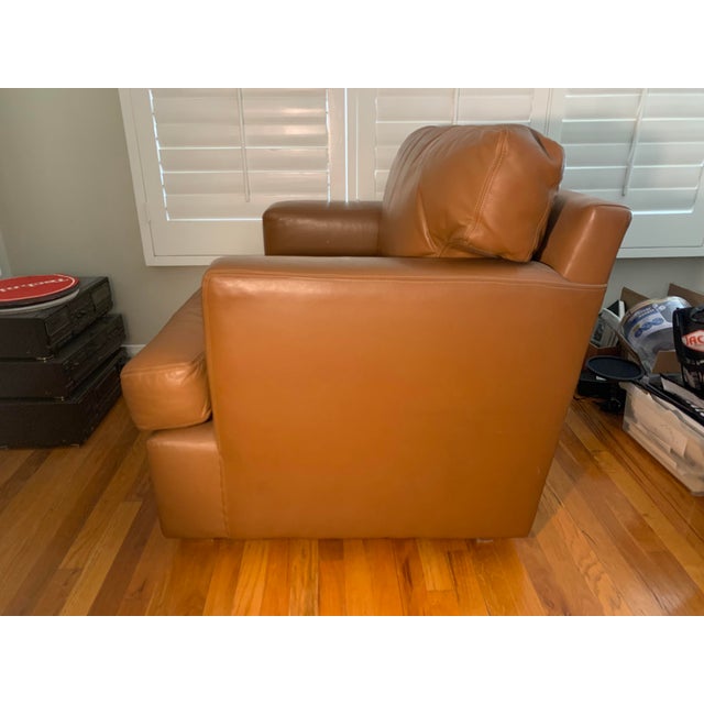 Late 20th Century Leather Chair upholstered in camel colored leather. With fitted loose seat and back cushion.