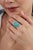 This vintage-style cocktail ring features a 6.7-carat natural mixed-cut turquoise, set in 14k yellow gold. The center...