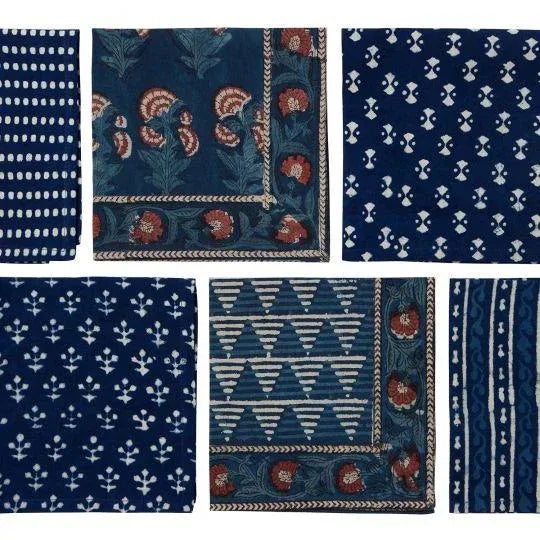 The Carnation design showcases the classic botanical carnation motif in brick red and off-white set against a deep indigo...