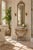 A petite Spanish reproduction demi-lune console table with a richly veined marble top and sculptural carved base in a warm...