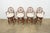 A charming set of four vintage faux bamboo swivel bar stools dating to the late 1970s to 1980s, featuring circular...