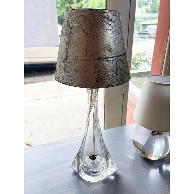 This stunning mouth-blown Murano glass table lamp is accompanied by a silver faux-painted shade. The piece has a delicate...