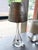 This stunning mouth-blown Murano glass table lamp is accompanied by a silver faux-painted shade. The piece has a delicate...
