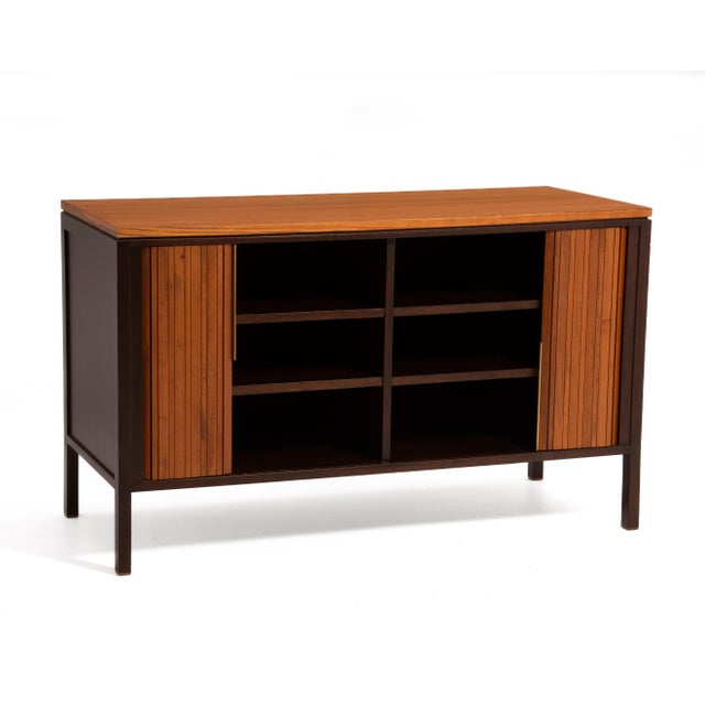 A Mid-Century tambour front cabinet or credenza designed by Edward Wormley for Dunbar Furniture of Bernie, Indiana....