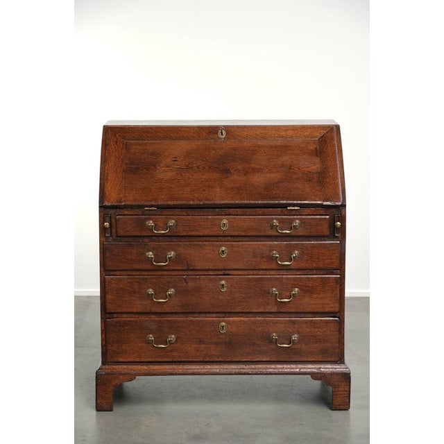 This exquisite 18th-century English oak secretary desk features a beautiful interior and a lovely original leather top....
