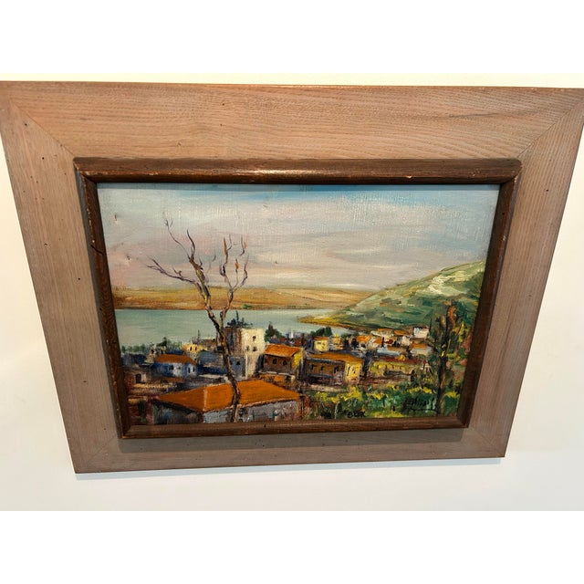 This is looks to be a mediterranean village seascape oil painting. It has its original frame and wire to hang. There are...