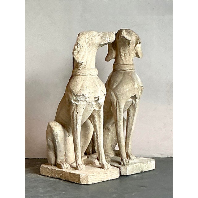 Presenting a stately pair of vintage Regency-style cast concrete dog statues, imbued with an air of classic elegance and...