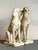 Presenting a stately pair of vintage Regency-style cast concrete dog statues, imbued with an air of classic elegance and...