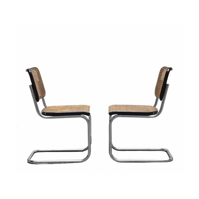 Set of two Cesca chairs designed by Marcel Breuer, with backrest and seat in black-stained wood and Vienna straw....