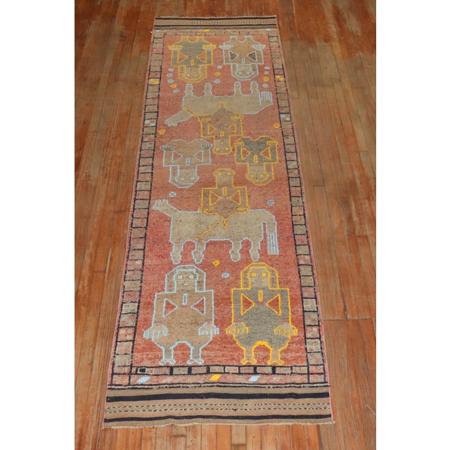 A decorative one of a kind colorful mid 20th-century turkish runner featuring animals and humans Measures: 3' x 10'11''