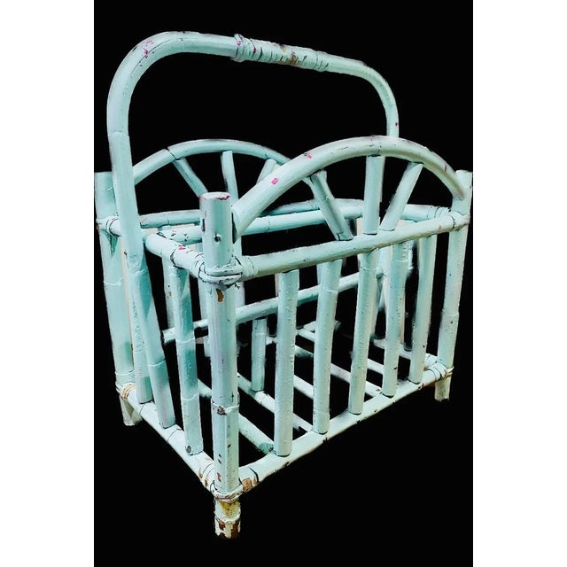 A fun aqua blue vintage magazine rack, with small spots of pink. Very distressed Circa 1960s-1970s A great piece for a...