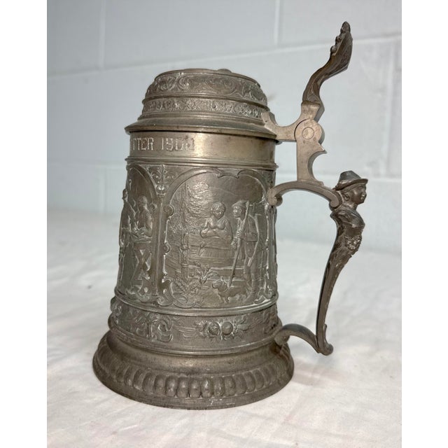 This large antique ornate figural German pewter lidded beer stein is a unique and collectible piece of breweriana. Made in...