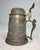This large antique ornate figural German pewter lidded beer stein is a unique and collectible piece of breweriana. Made in...