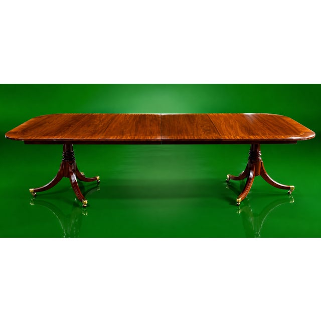This Baker Furniture Georgian Banded Mahogany Double Pedestal Extension Dining Table is a gorgeous, substantial and...