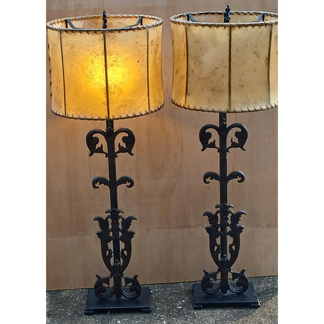 Tuscan with Texas flair! Solid iron Tuscan style lamp pair with animal hide shades. As fitting for the den as it is for...