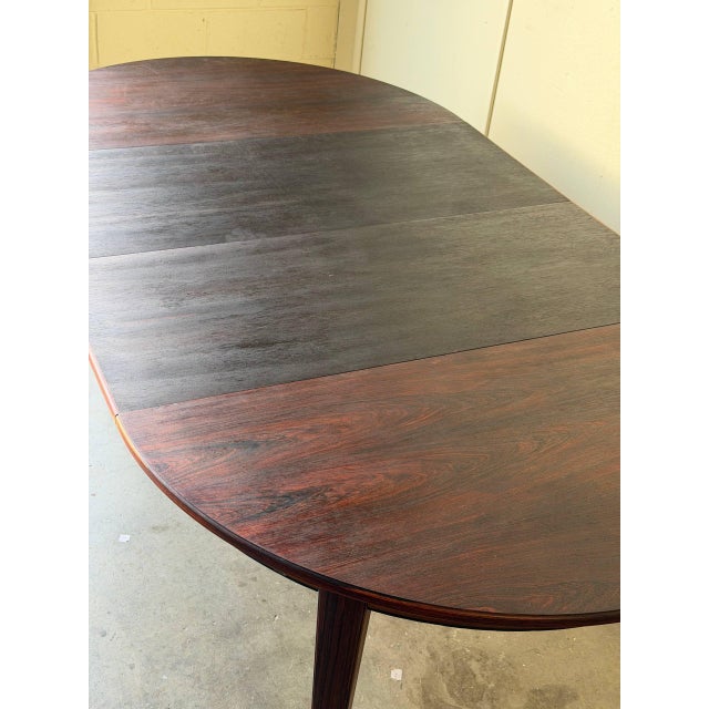 Beautiful Danish Mid Century Modern dining table crafted in richly grained rosewood. This elegant oval table features...