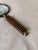 A distinctive vintage magnifying glass with a carved wooden handle inspired by a dice, finished with small brass coloured...
