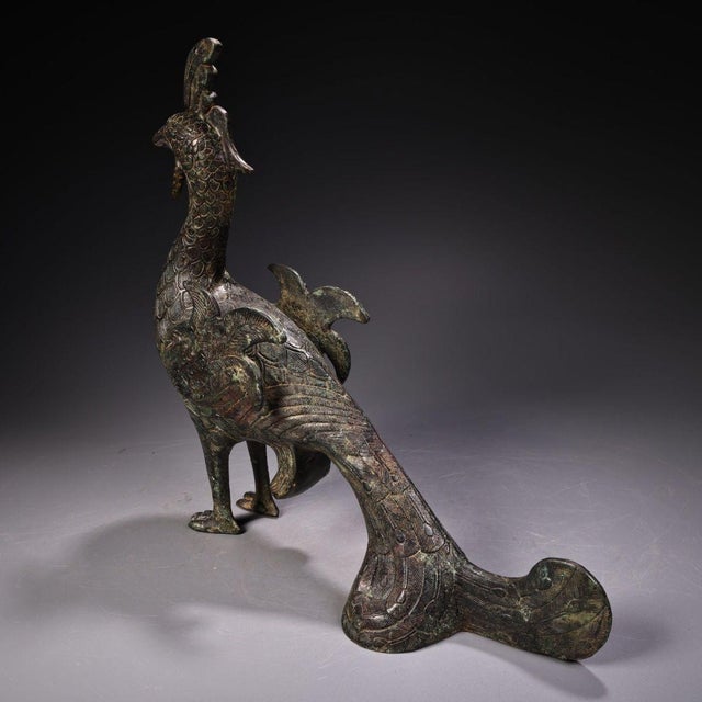 This striking antique bronze sculpture depicts a standing peacock, a traditional symbol of beauty, dignity, and good...