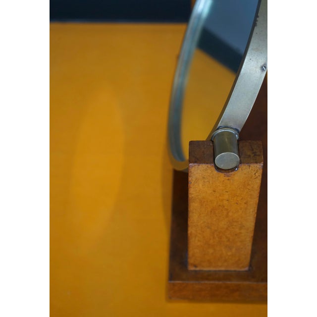 A very rare table mirror designed by Emile-Jacques Ruhlmann. It is made using maple burr wood and has a nickel plated...