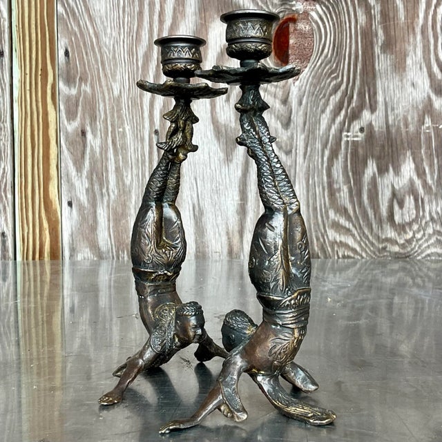 A fantastic pair of vintage Boho candlesticks. A chic patinated metal in a dark bronze color. Two acrobatic figures in a...