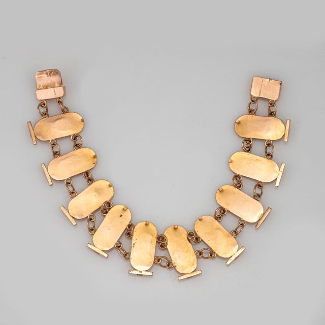 Stylish vintage Egyptian themed cartouche bracelet crafted in 14 karat yellow gold (circa 1970s). The bracelet depicts two...